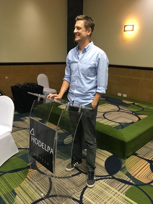 Photo of Koen Voorend standing at podium in conference room